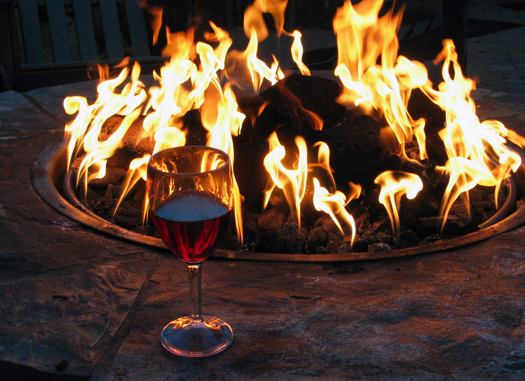 Wine glass by outdoor fire pit