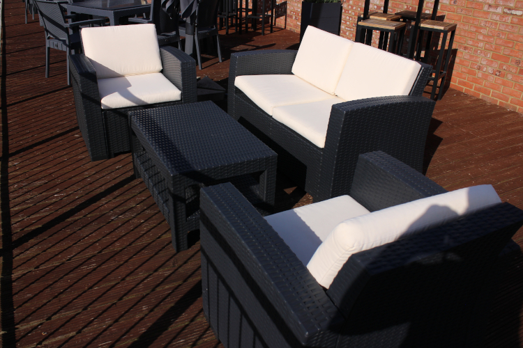 rattan sofa and armchair set on decking.
