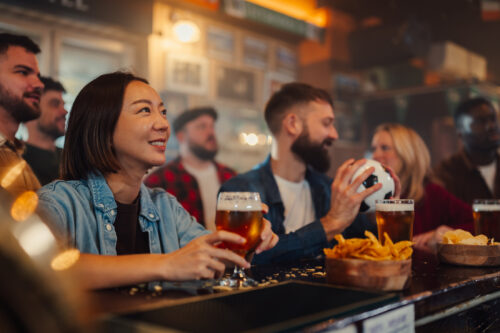 group of friends watching football at pub