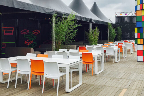 multiple switch flow dining tables outdoors at a festival, white frame with white high pressure laminate table tops