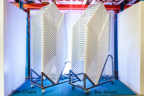 Kasar side chairs and Kasar bar stools stacked 30 high, each on their own trolley