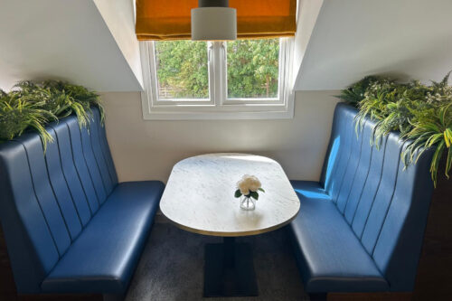Bench seating in a booth configuration with rectangle dining table.