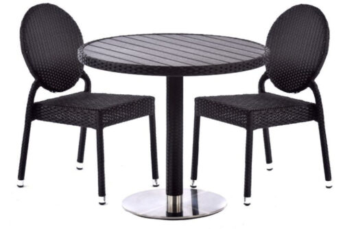 2 Rattan side chairs in black, with a curved backrest and chrome feet, next to a black rattan dining table with chrome base, on a white background.