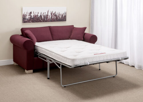 A purple double sofa bed, in a hotel room, with a white mattress fully extended.