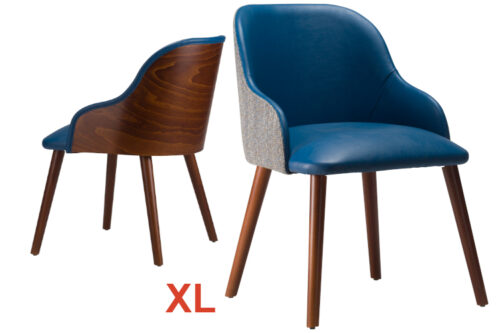 Front view of armchairs, side by side with arms. Both with blue faux leather and Walnut stained legs. One with an upholstered back, the other wooden back, both on a white background.